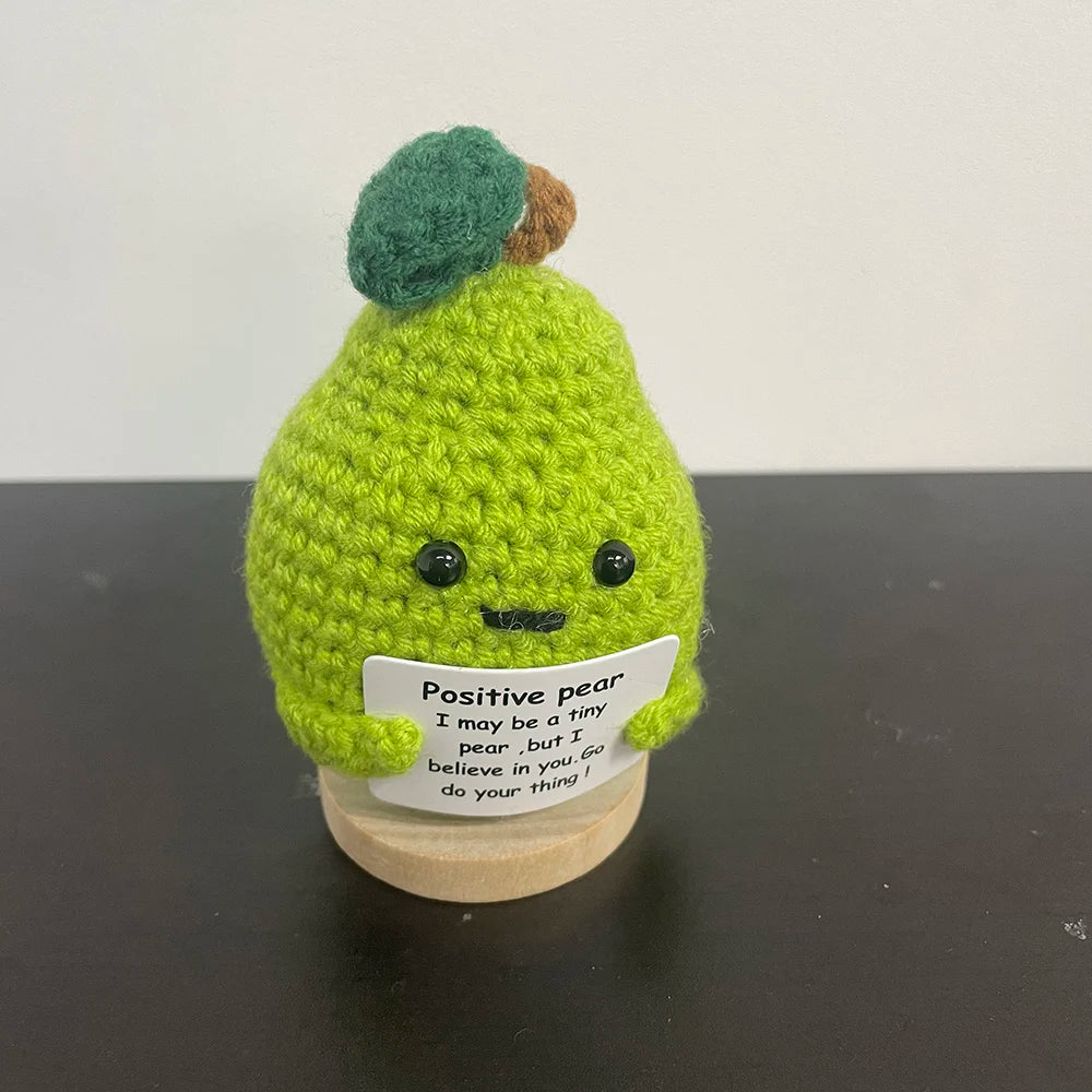 Cute handmade crochet pear plush holding a motivational sign, amigurumi fruit doll perfect for uplifting decor or gifts